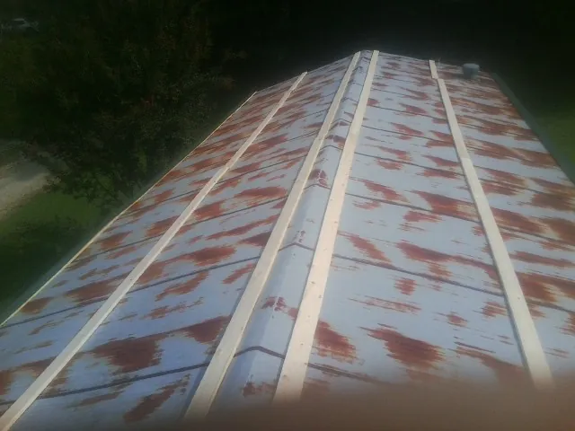 Rusted metal roof panels with new wood purlins before replacement — Storm Damage Roof Repair in Seymour by Roofing Brothers